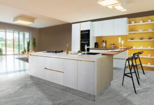 Sleek and modern kitchen interior featuring a large island and open shelving in a contemporary setting.